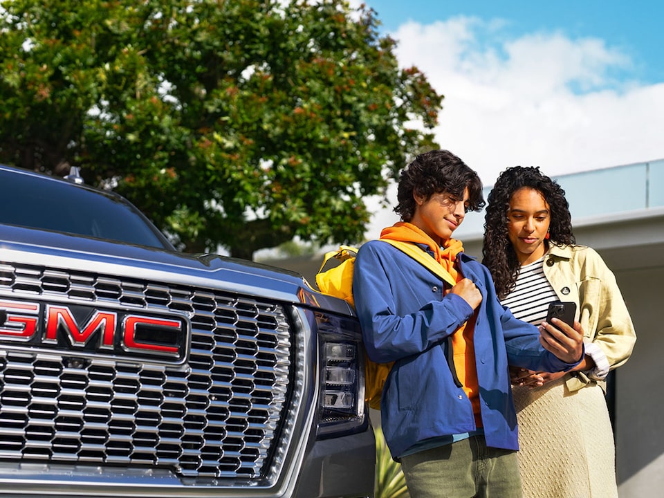Close-up of a Person Holding Their Smartphone with the myGMC App Open on the Vehicle Remote Start Page
