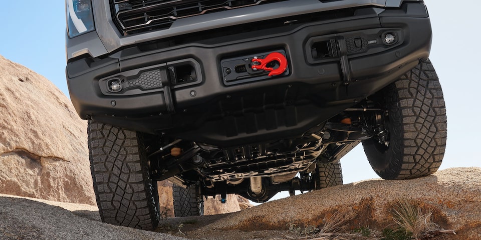 Close-up of the Front End on a 2025 GMC Sierra HD AT4 Truck Driving on Rocky Terrain