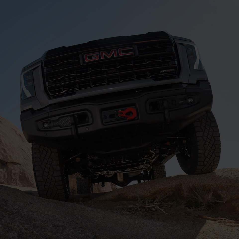 Close-up View of the Grille and Underside of a 2025 GMC Sierra HD Truck on Uneven Terrain