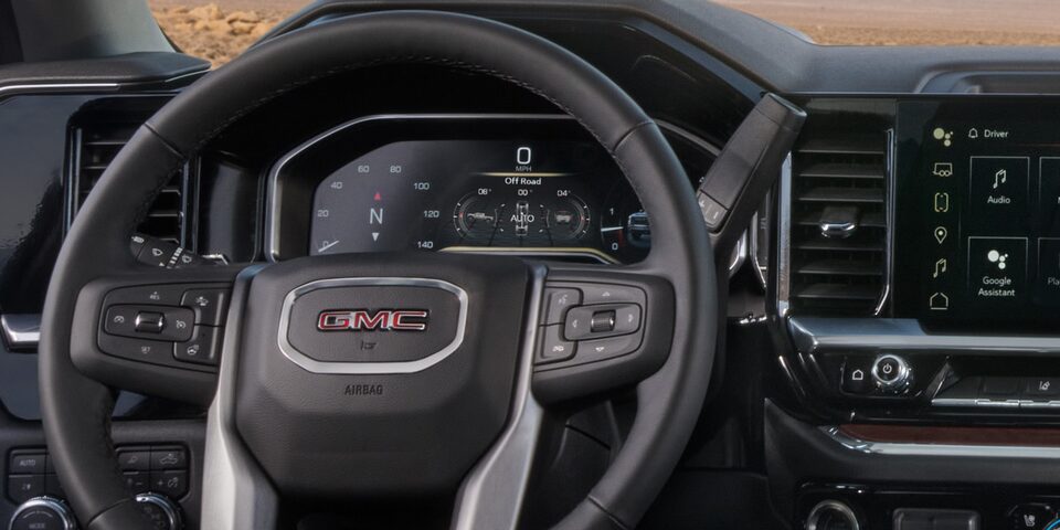 Close-up of the Steering Wheel, Digital Cockpit, and Infotainment System in a 2025 GMC Sierra HD Truck