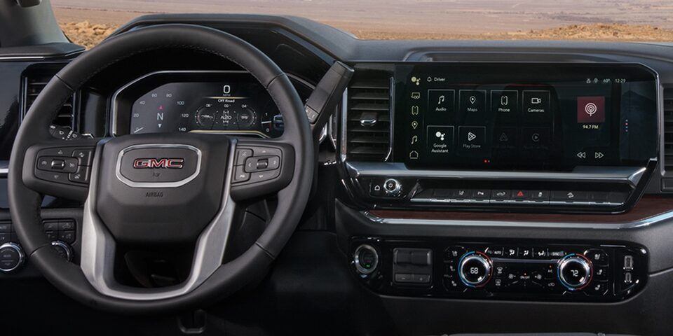 Close-up of the Steering Wheel, Digital Cockpit, and Infotainment System in a 2025 GMC Sierra HD Truck