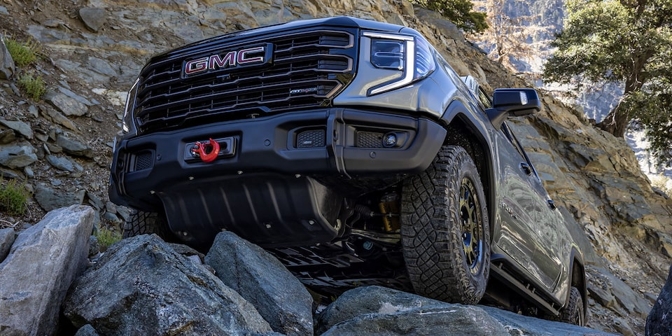 The GMC Sierra AT4 Off-Road Truck Driving Over Rough Terrain