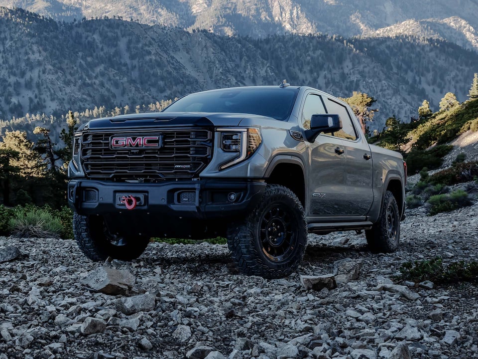 Front Three-Quarter View of the GMC Sierra 1500 AT4 Off-Road Truck Parked on Rocky Terrain