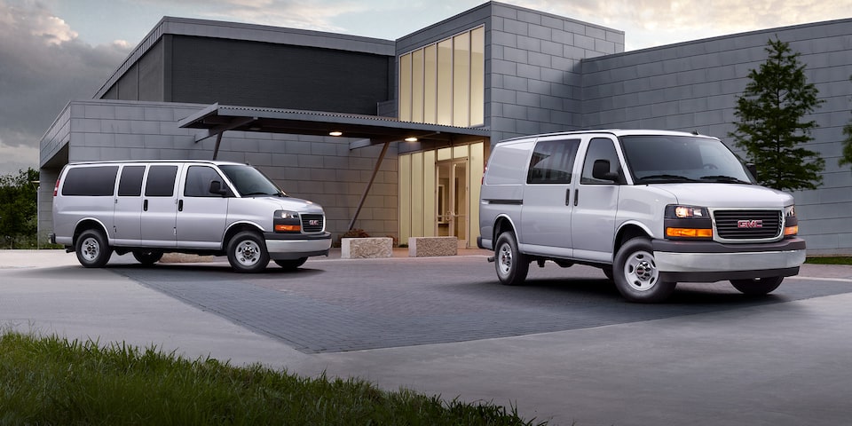 Two GMC Savana Cargo Vans Parked in a Driveway