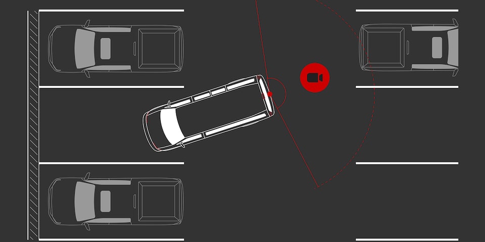 Rear Three-Quarters View of a 2025 GMC Savana Passenger Van Parked Outside of a Building