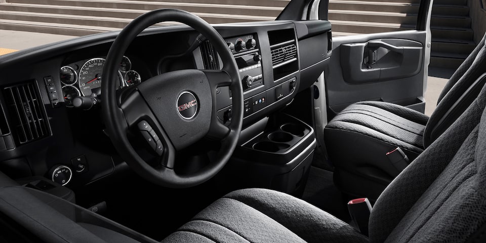 Interior View of the Steering Wheel, Dashboard, and Seating in a 2025 GMC Savana Passenger Van