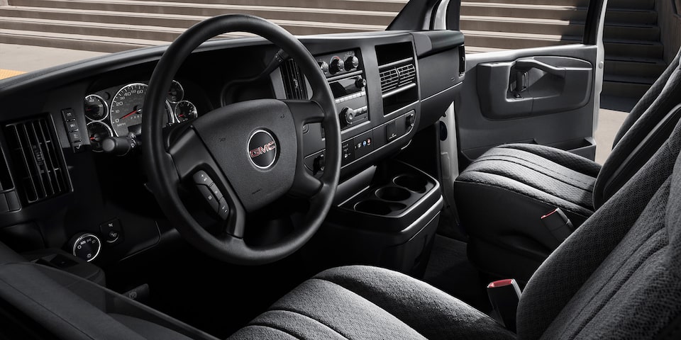 Interior View of the Steering Wheel, Dashboard, and Seating in a 2025 GMC Savana Passenger Van