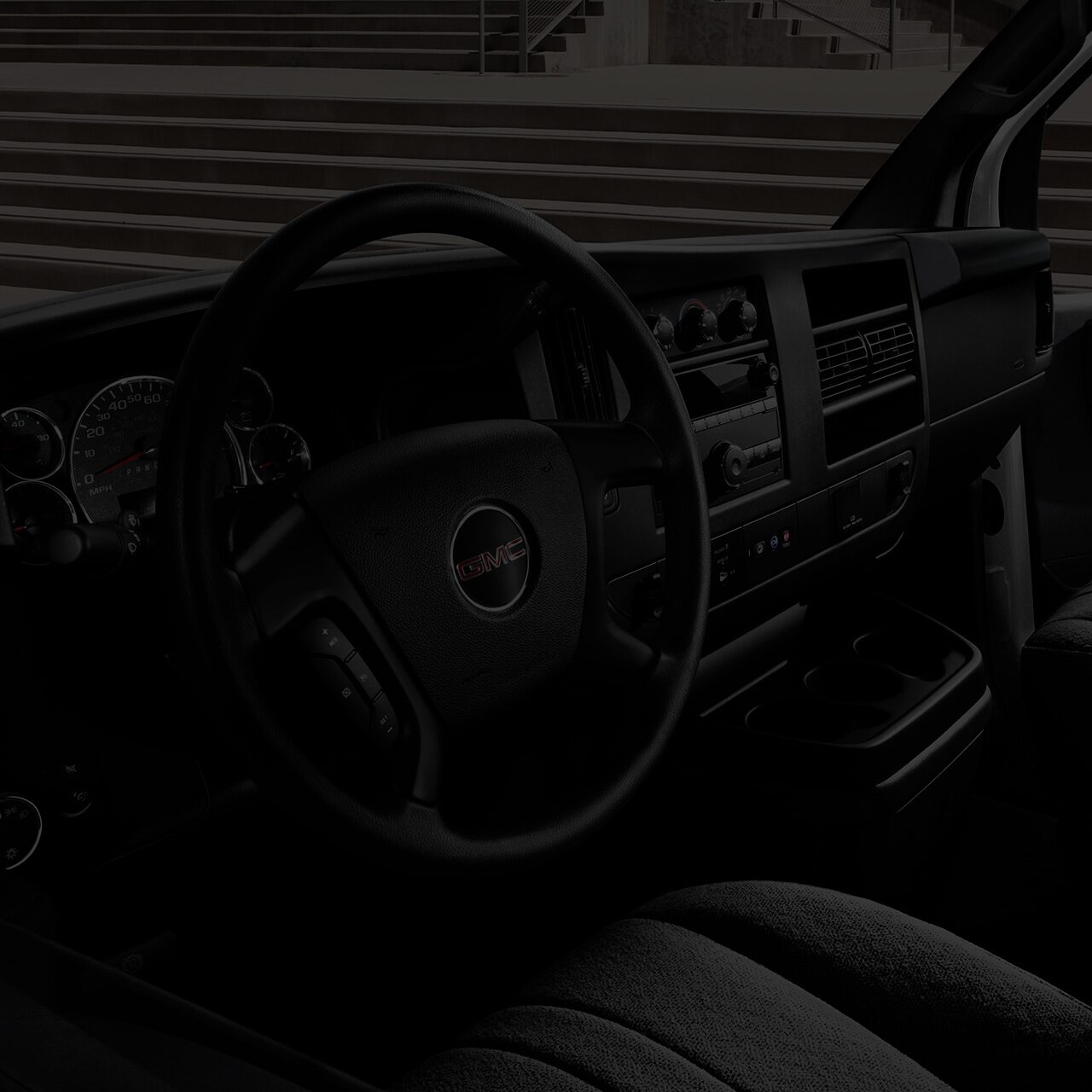 Interior View of the Steering Wheel, Dashboard, and Seating in a 2026 GMC Savana Cargo Van