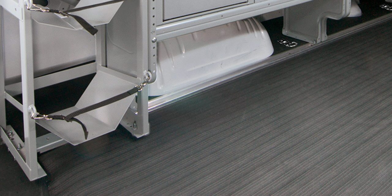 Close-up of the Textured Black Rubber Floor Matting with a Silver Trim in a 2026 GMC Savana Van