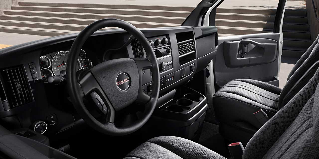 Interior View of the Steering Wheel, Dashboard, and Seating in a 2026 GMC Savana Cargo Van