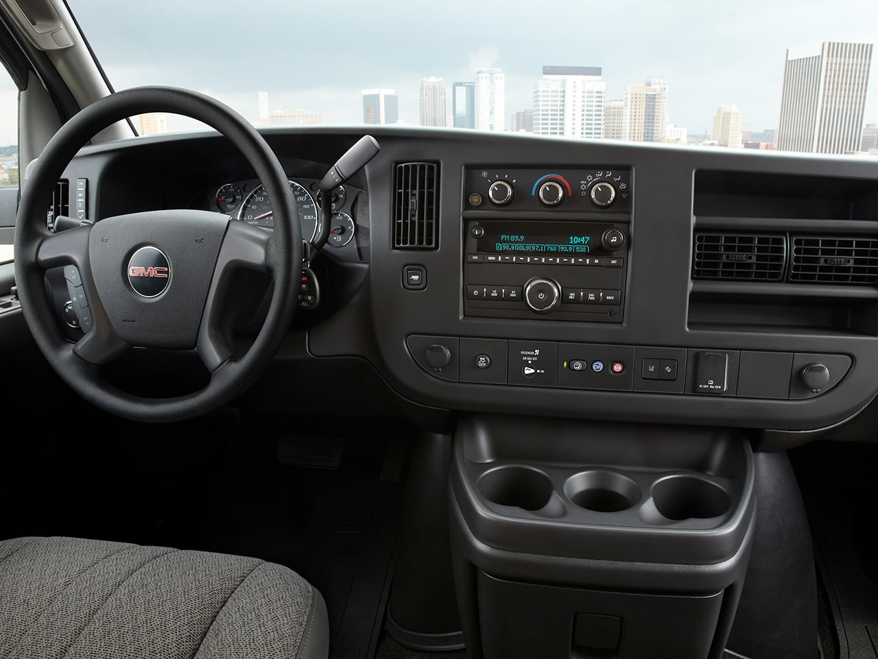 Wide Interior View of the Steering Wheel and Dashboard in a 2026 GMC Savana Passenger Van