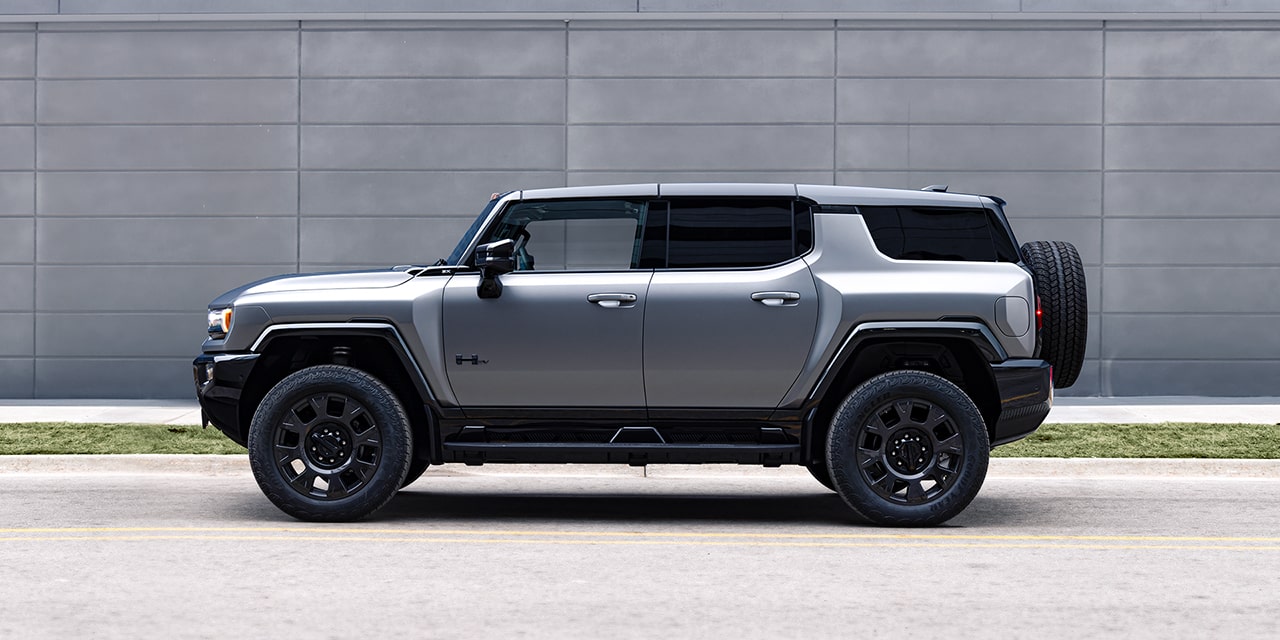 Driver Side View of the 2026 GMC HUMMER EV SUV Parked by a Concrete Wall