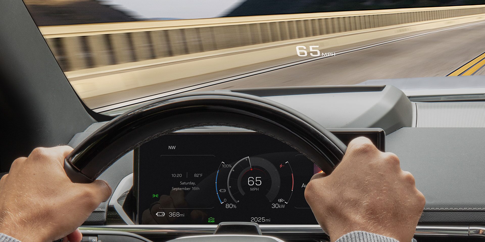 The Head-up Display Feature Being Used as a Man Drives his 2026 GMC Sierra EV AT4