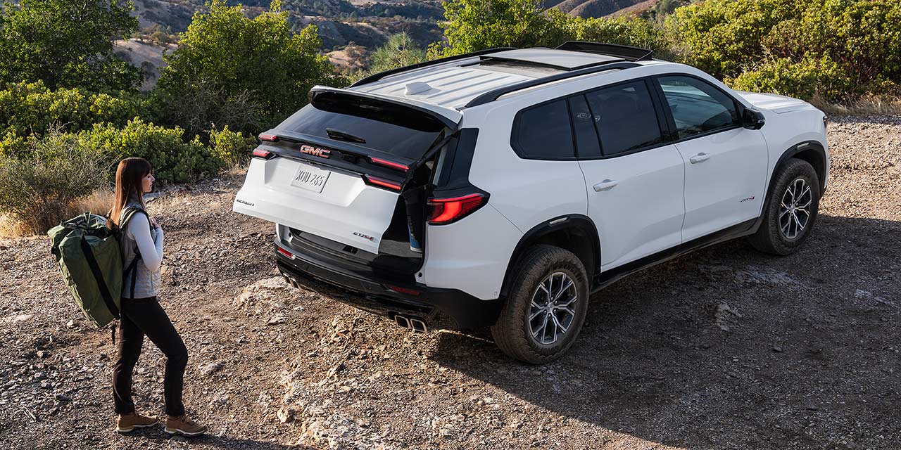 Birds-eye View of a Man Using the Autosense Power Liftgate on the GMC Acadia AT4 Mid-Size Off-Road SUV