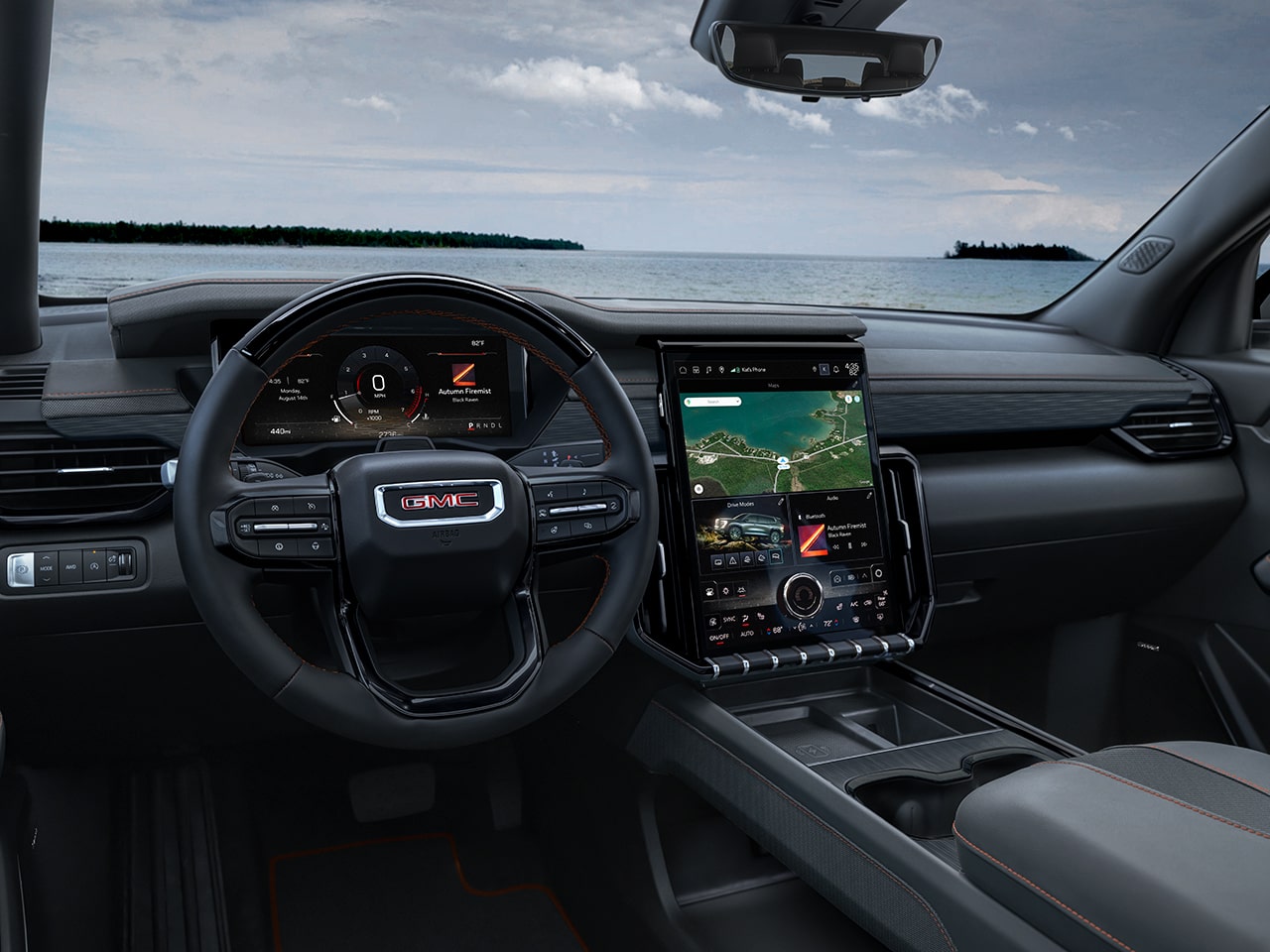Interior Close-up View of the Steering Wheel and Infotainment System in the GMC Acadia Mid-Size SUV