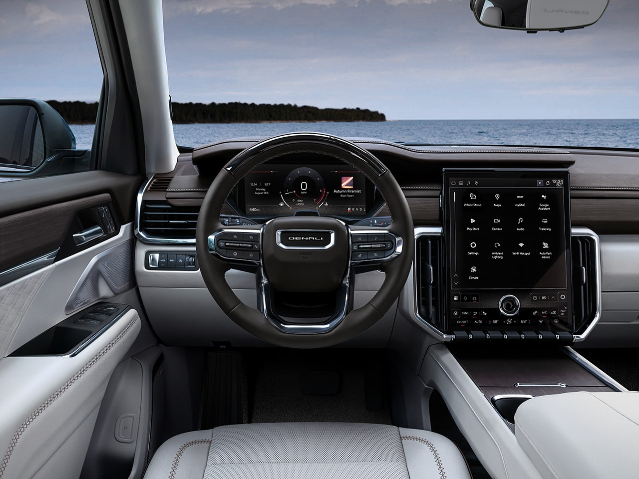 Interior Close-up View of the Steering Wheel and Infotainment System in the GMC Acadia Denali Luxury Mid-Size SUV
