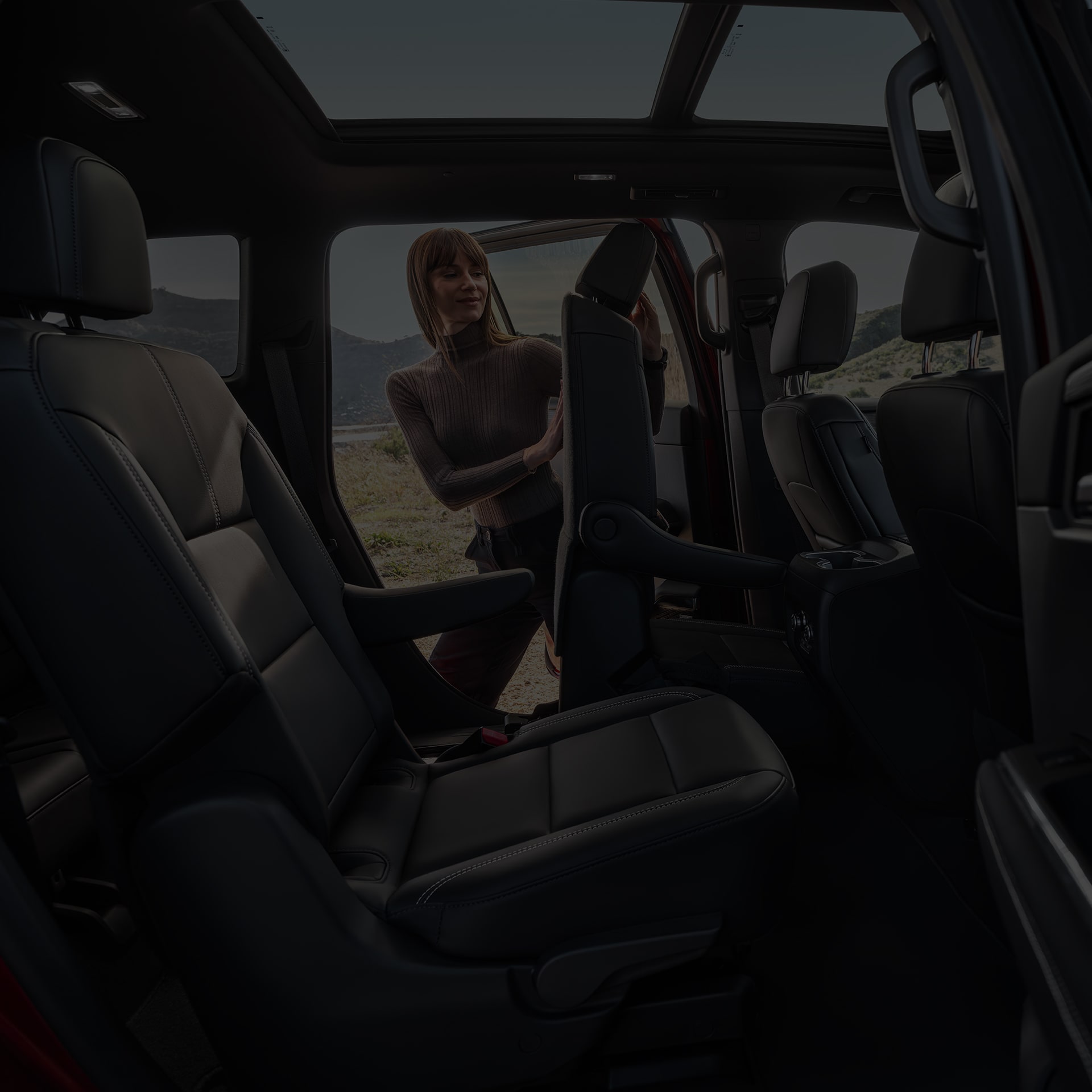 Interior View of the Rear Seats in the 2026 GMC Acadia Mid-Size SUV from the Passenger Side Rear Door