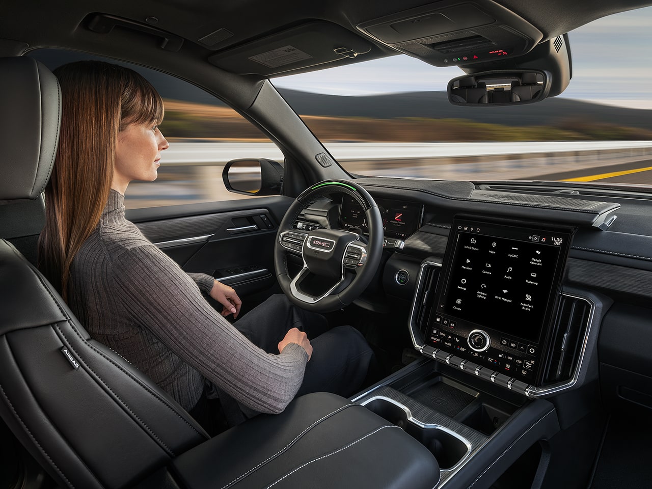 Profile View of a Woman Using Super Cruise Driver Assistance Technology in the 2026 GMC Acadia Mid-Size SUV