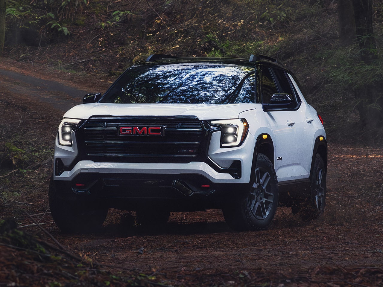 View of the 2026 GMC Terrain AT4 Small Off-Road SUV Parked in the Woods