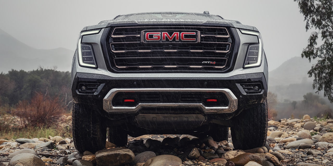 Front View of the Grille on the 2026 GMC Yukon AT4 Full-Size Off-Road SUV Driving Off-Road