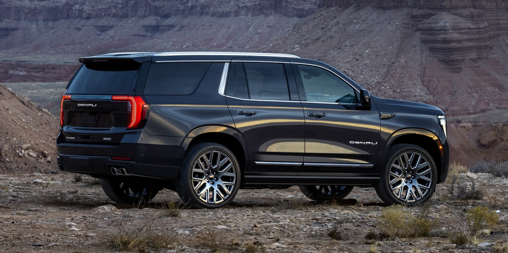 Rear Three-Quarter View of the 2026 GMC Yukon Large SUV Parked in a Mountain Range