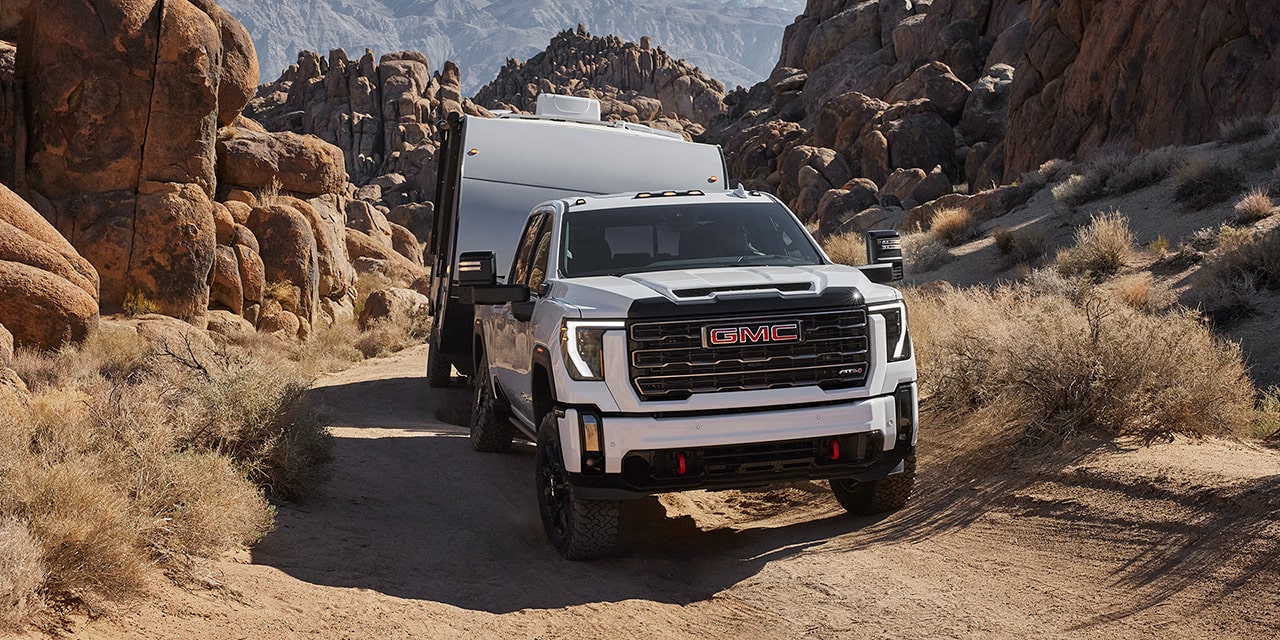 The 2026 GMC Sierra HD Heavy Duty AT4 Heavy Duty Off-Road Truck Hauling a RV Through a Dirt Road