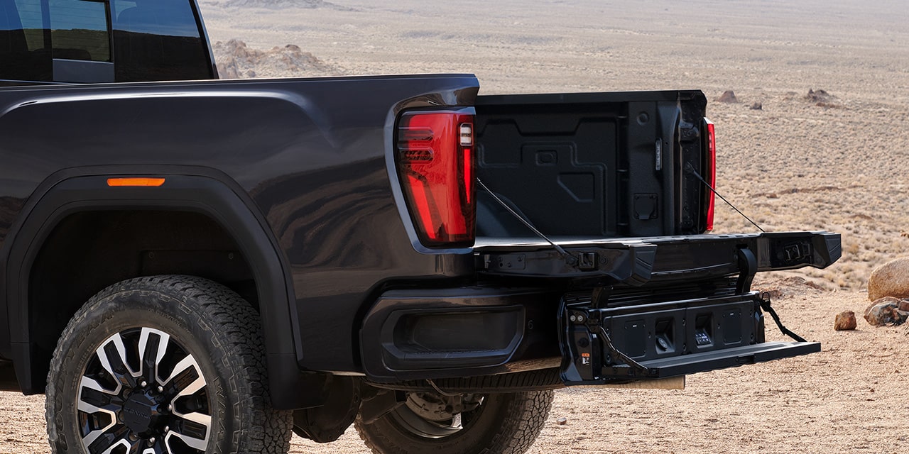 Close-up View of the MultiPro Tailgate with Step Lowered on a 2026 GMC Sierra HD Truck