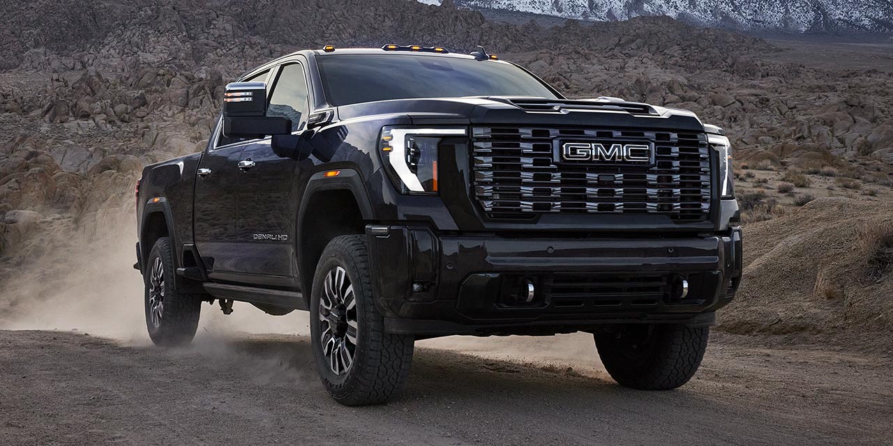 The 2026 GMC Sierra HD Heavy Duty Truck Driving Through a Mountain Road and Kicking up Dust