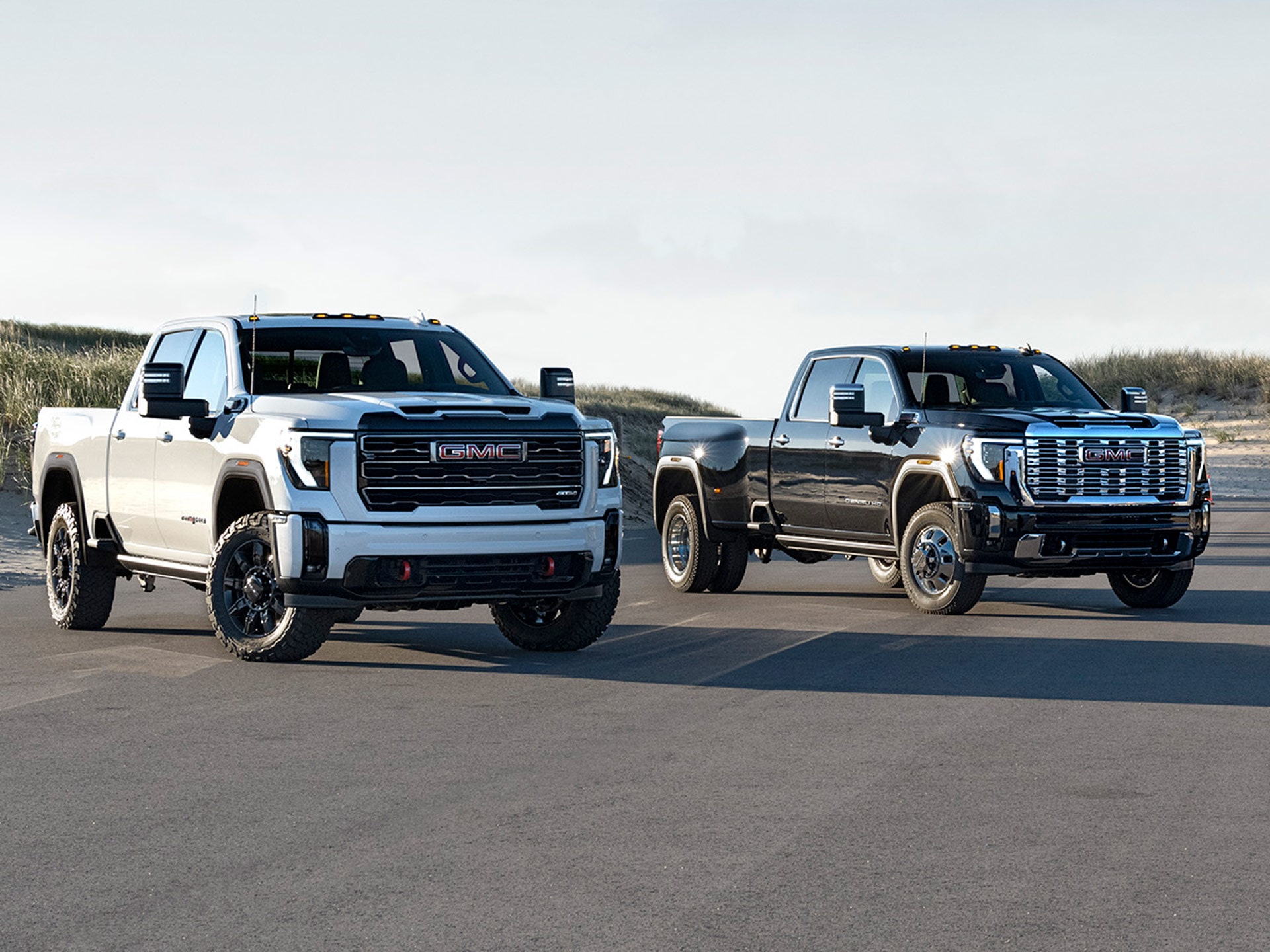 Lineup of 2026 GMC Sierra HD Heavy Duty Trucks Parked Near Each Other