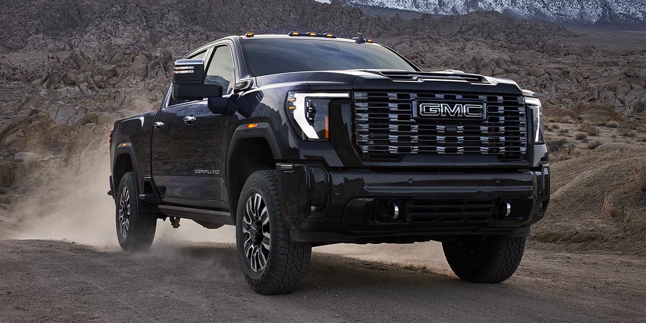 The 2026 GMC Sierra HD Heavy Duty Truck Driving Through a Mountain Road and Kicking up Dust