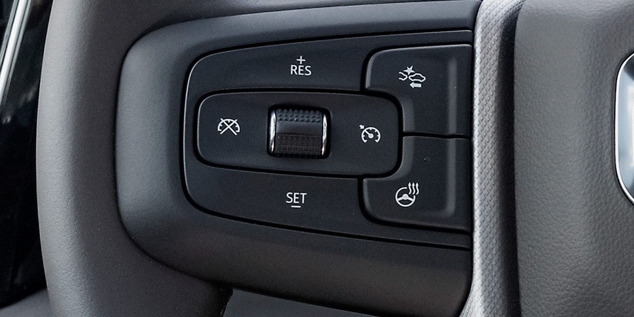 Close-up of the Adaptive Cruise Control with Trailering Controls on the Steering Wheel of the GMC Sierra HD Heavy Duty Truck