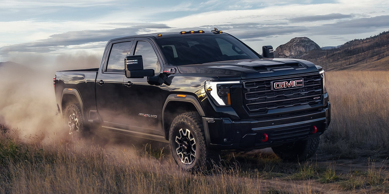The 2026 GMC Sierra HD Heavy Duty Truck Driving Off-Road and Kicking up Dust