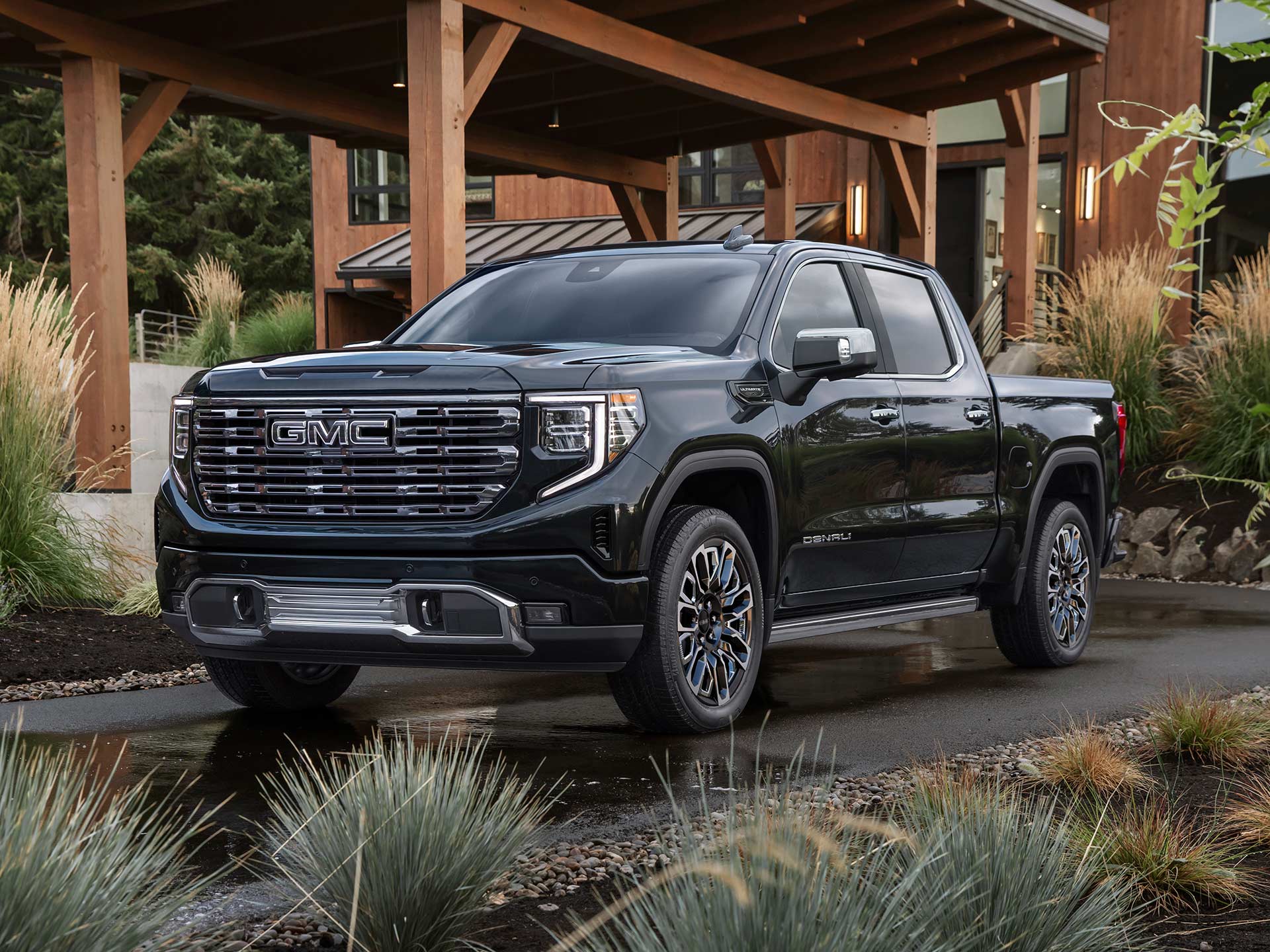 The 2026 GMC Sierra 1500 Pickup Truck Parked in a Driveway to a Cabin in the Forest