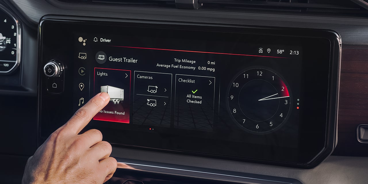 Close-up of a Driver Using the In-Vehicle Trailering App on the Infotainment Screen of the 2026 GMC Sierra 1500
