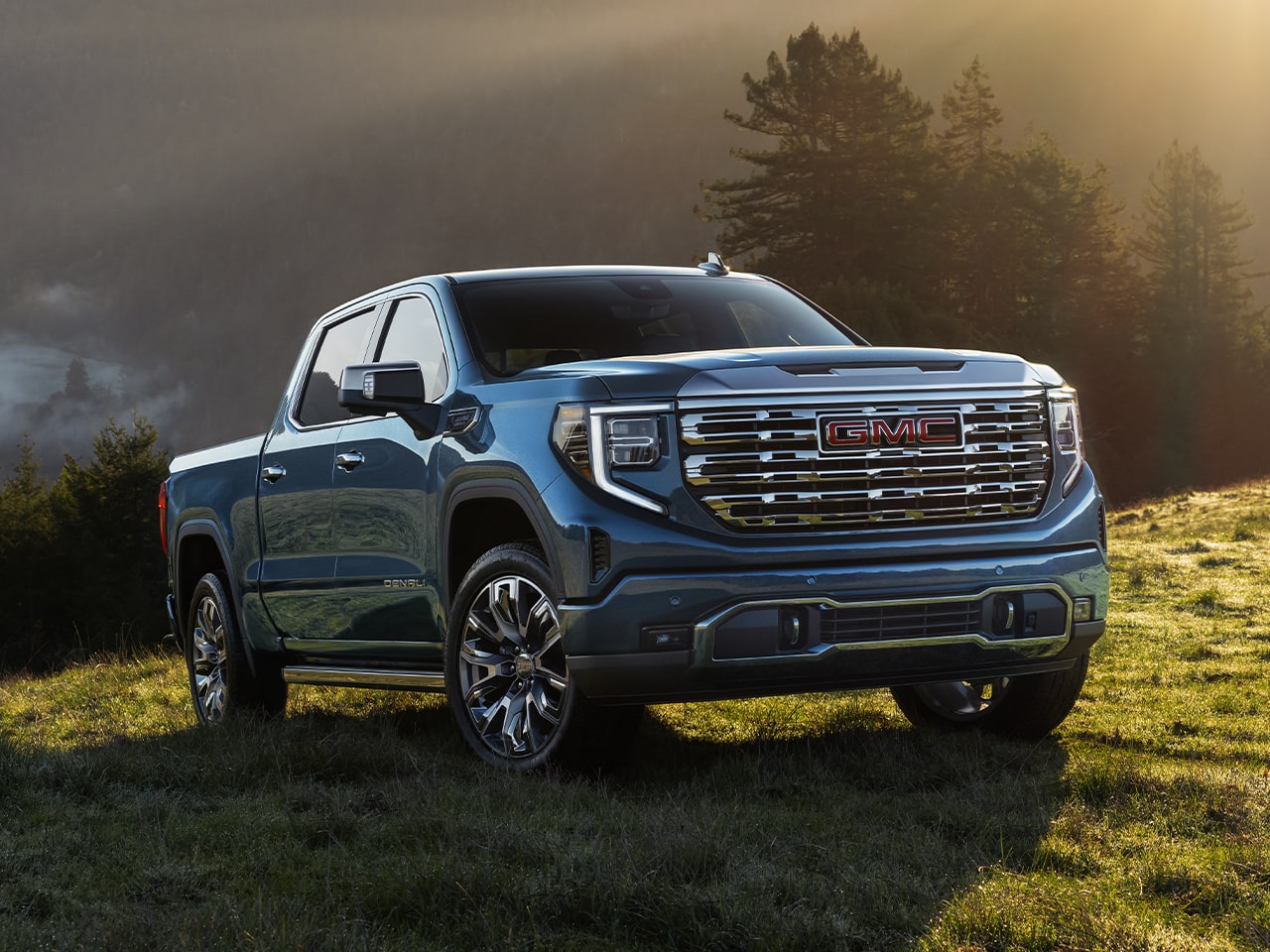 The 2026 GMC Sierra 1500 Pickup Truck Parked in a Green Valley at Sun Rise