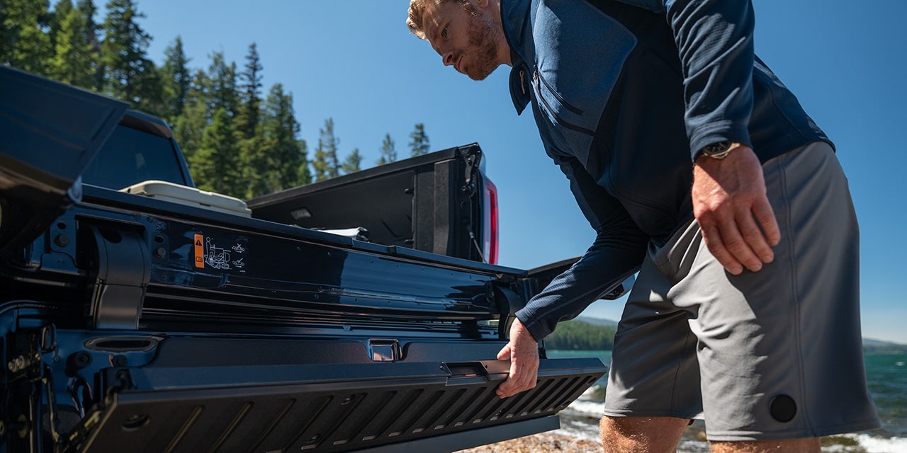 A Man Using the Multipro Tailgate on his 2026 GMC Sierra 1500 Pickup Truck