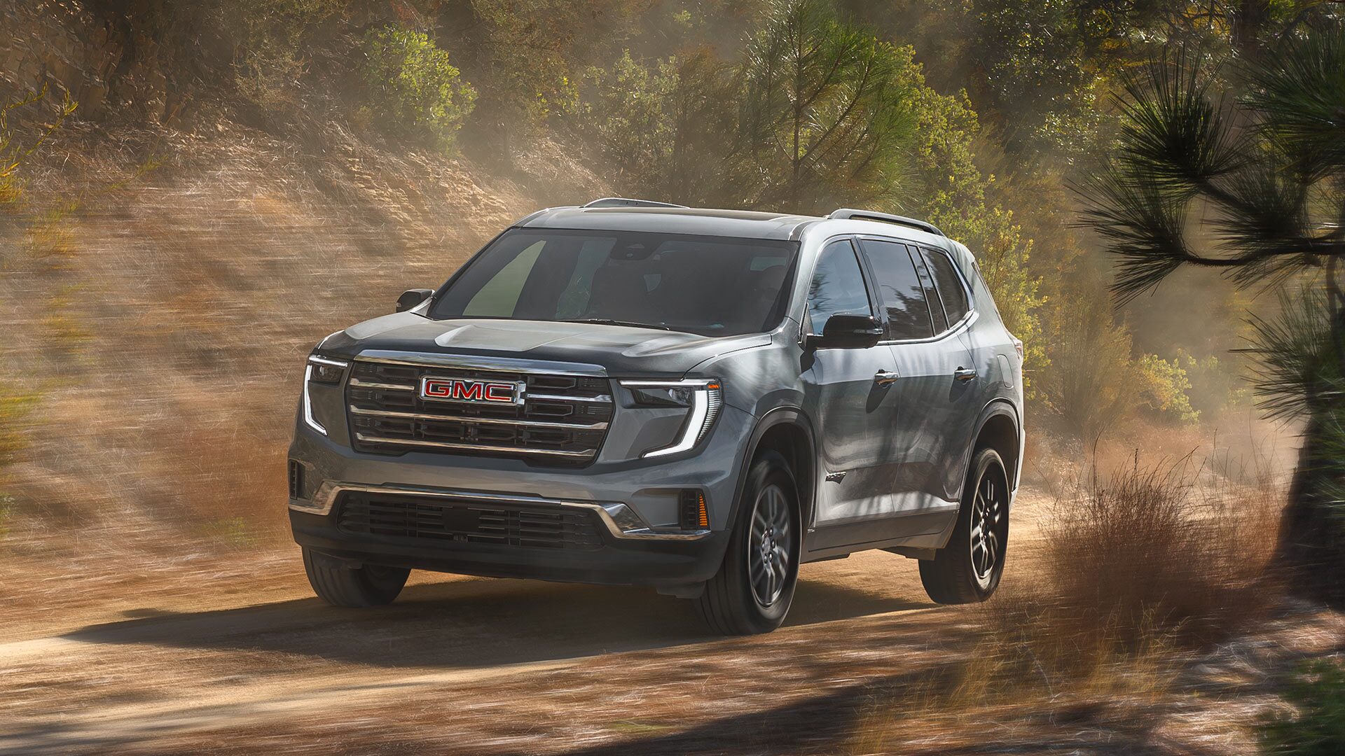 The GMC Acadia Driving Down a Dirt Road