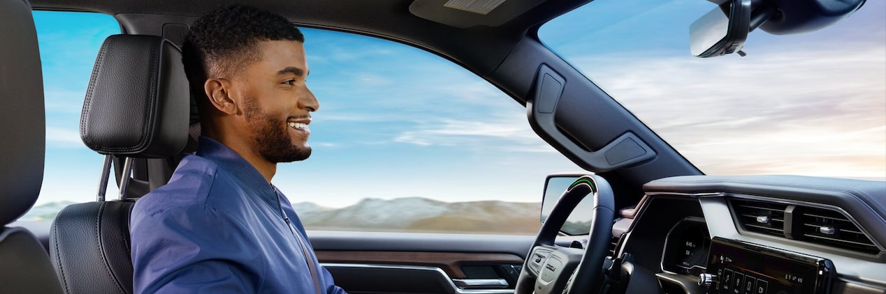 Profile View of a Man Smiling While Driving in his GMC Vehicle