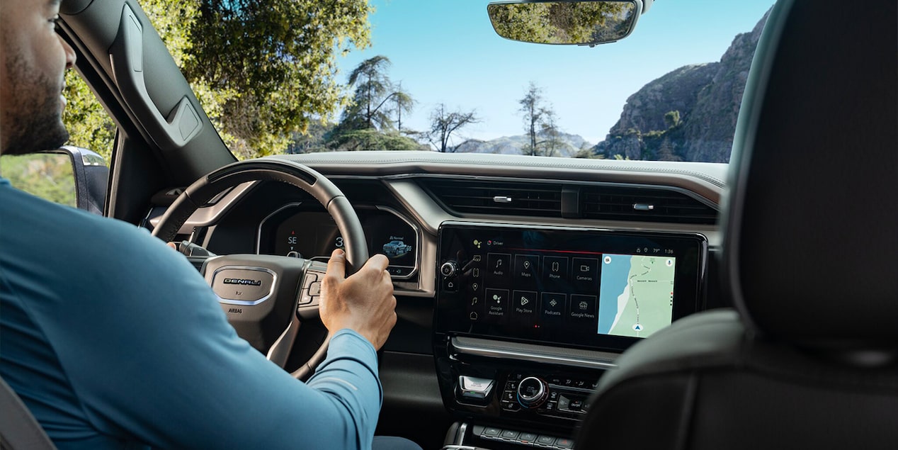 Over the Shoulder View of a Man Driving His GMC Vehicle