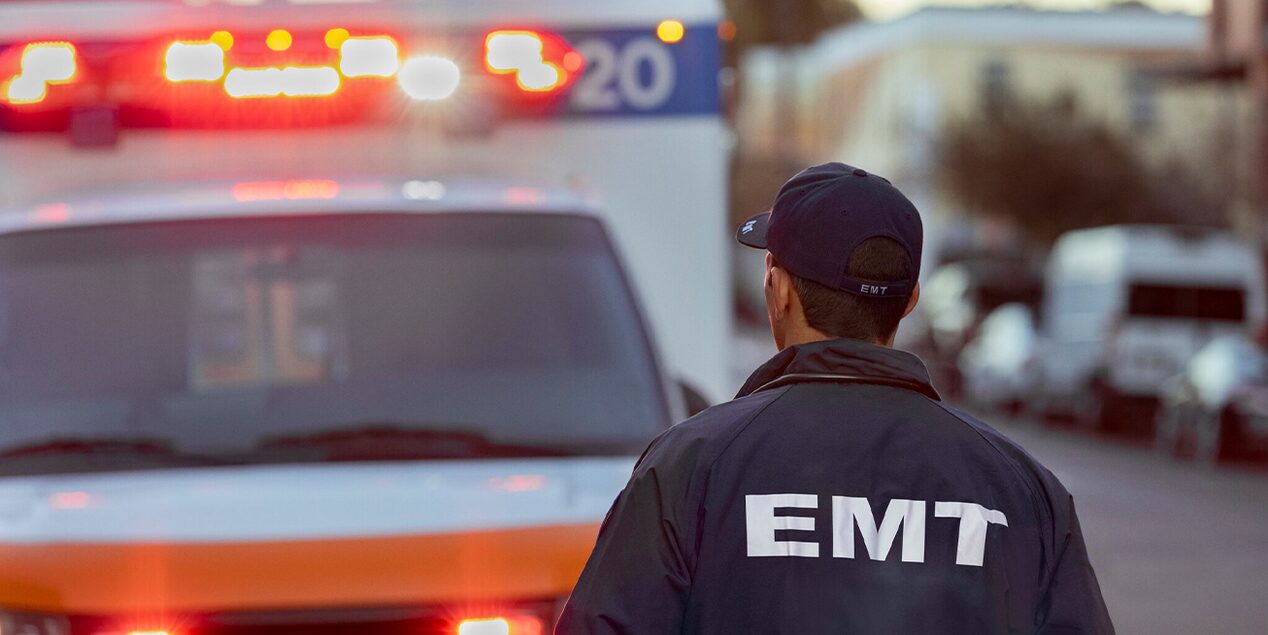 An EMT Walking Back to the Ambulance