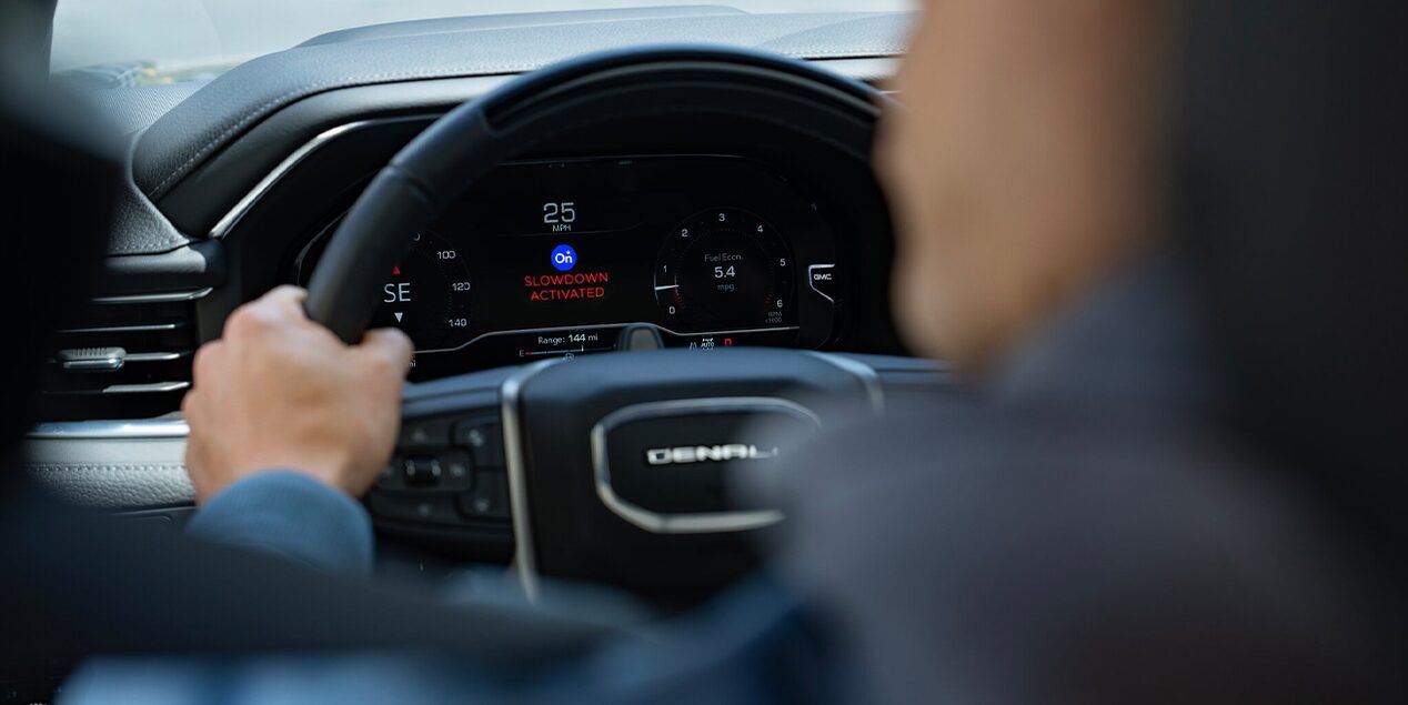 Over the Shoulder Focused View of a Vehicles Steering Wheel and Dashboard