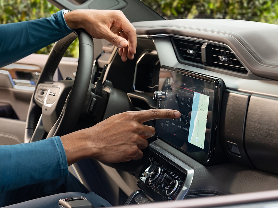 Close-up of the Driver Using OnStar Navigation on Their Vehicle's Infotainment System