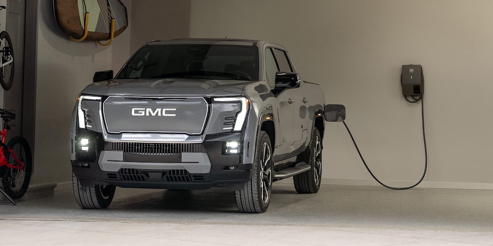 Front Three-Quarter View of a GMC HUMMER EV Pickup Truck Charging at Home