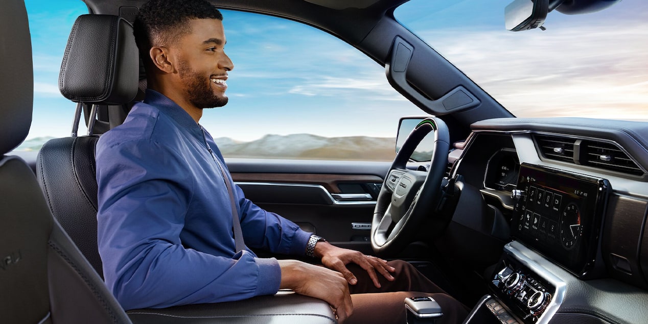 Profile View of a Man Smiling While Driving in his GMC Vehicle